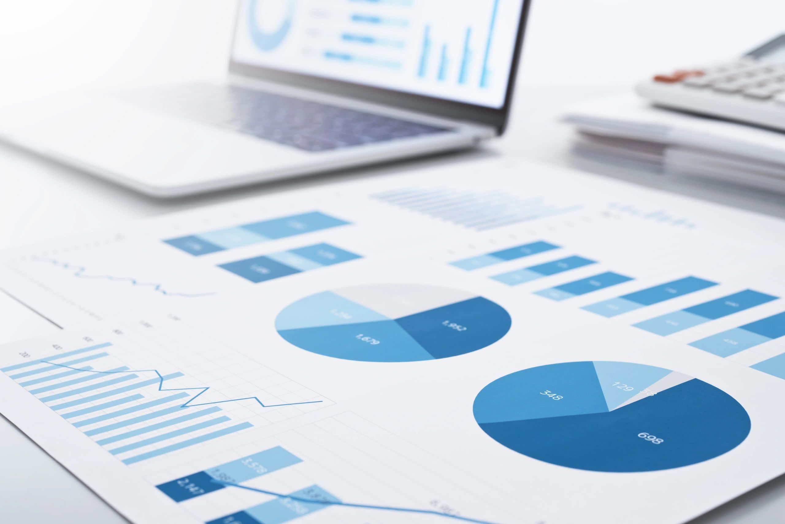 Reports and laptop representing performance tracking and insights