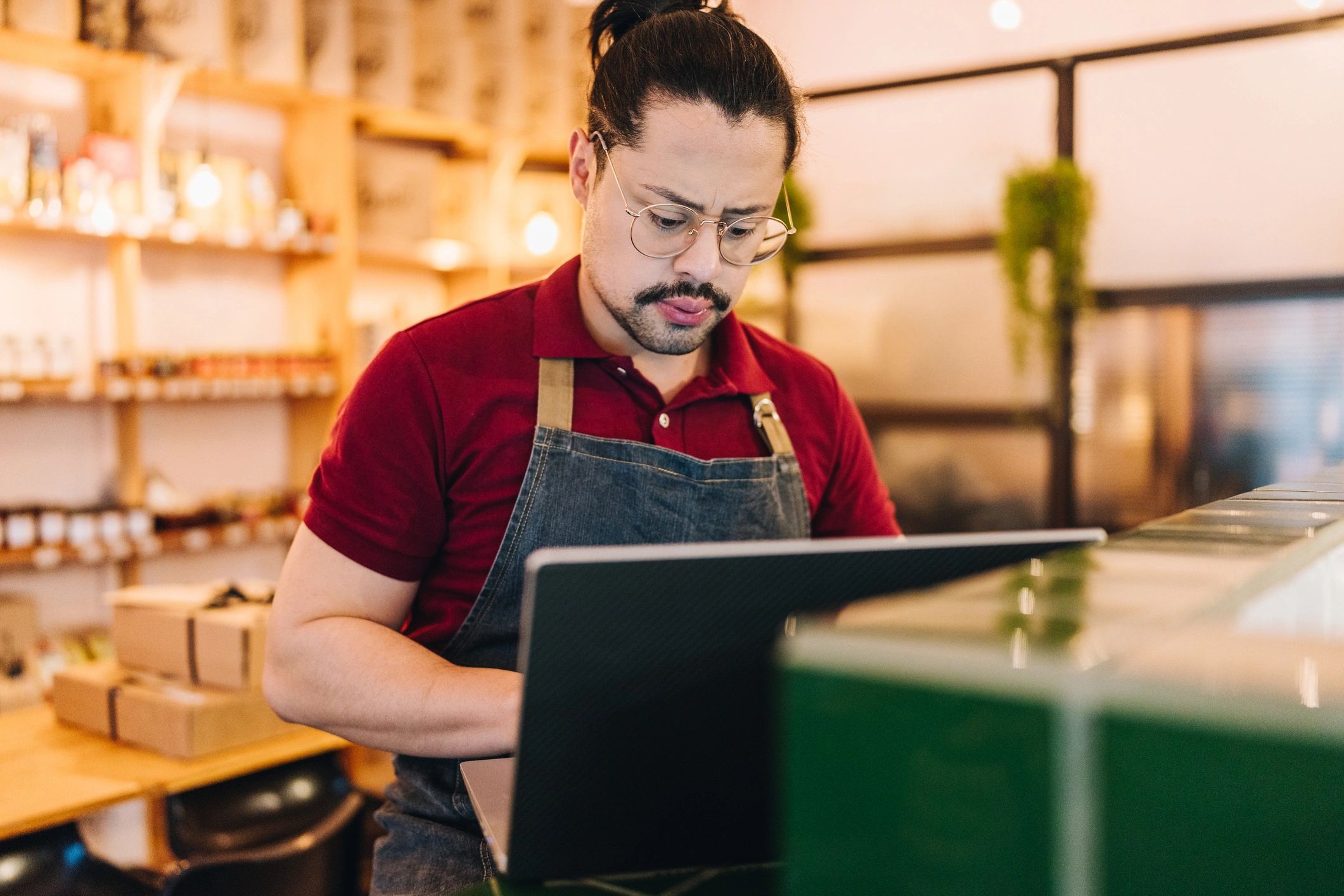 Small business owner using a laptop at a desk
