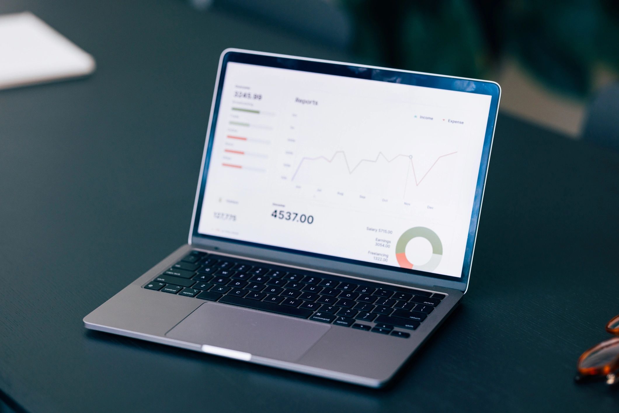 Data graphs on laptop representing reporting and optimization